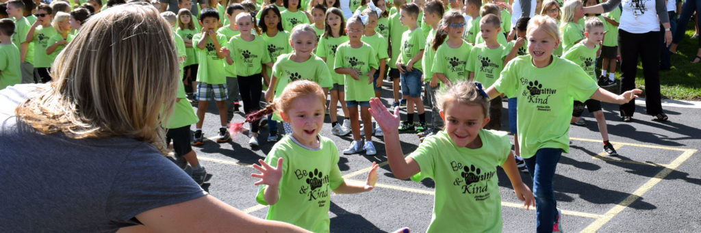 Students race to give their teacher a High Five